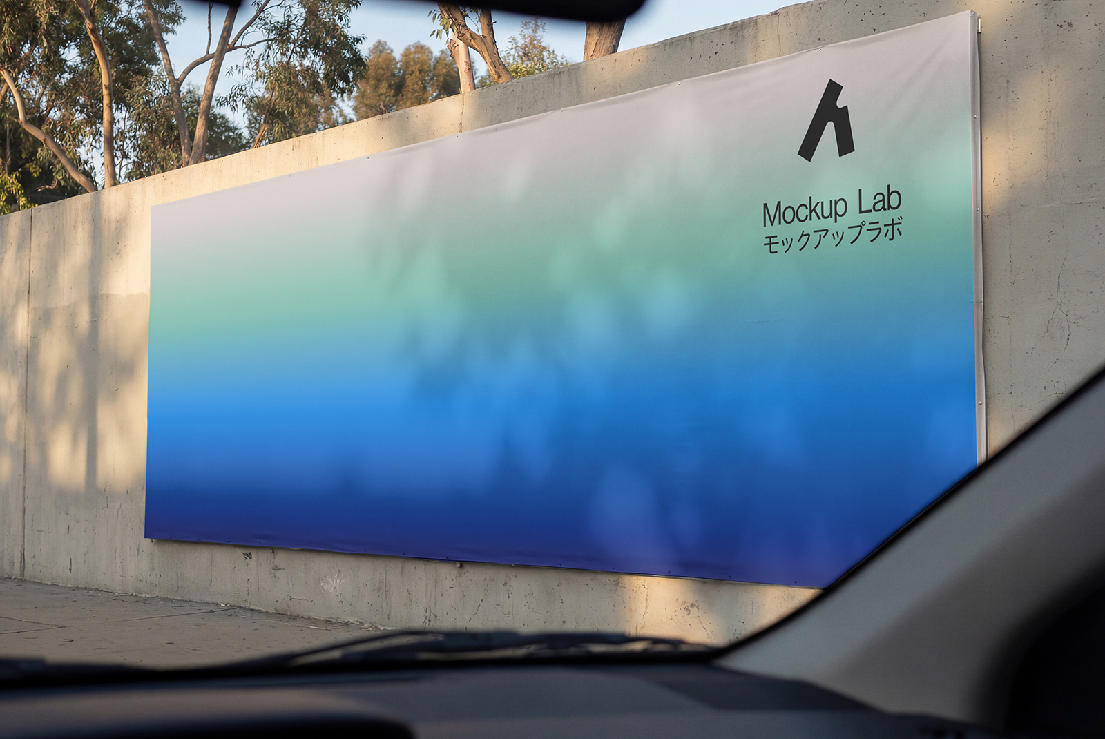 Front view of a large billboard mockup positioned against a clear blue sky.